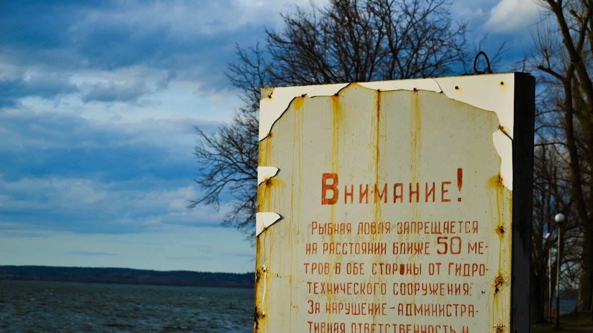 Sign near water warns of danger.